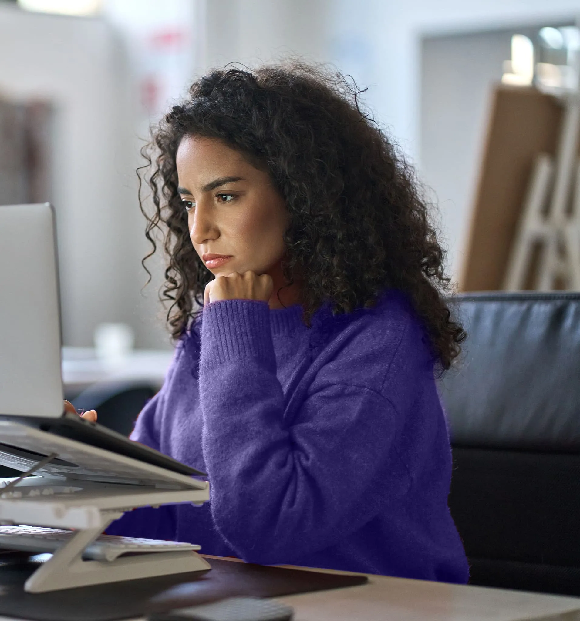Woman looking pensive at computer